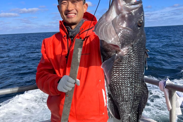 a person holding a fish in the water