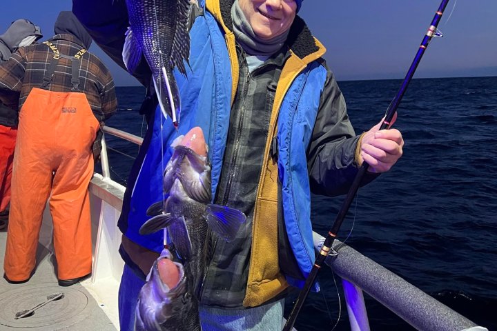 a person holding a kite while standing in the water