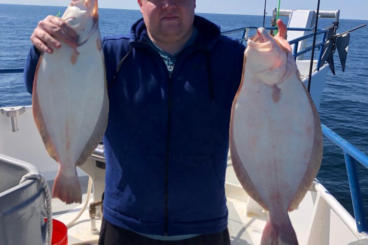 a man holding a fish