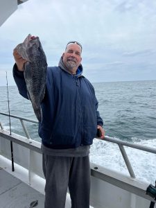 a man holding a fish in the water