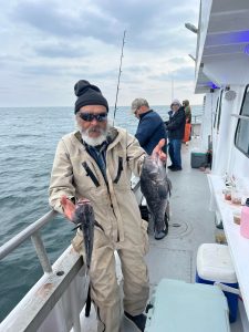 a man holding a fish in the water