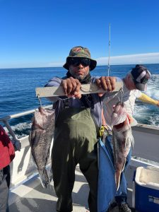 a man holding a fish in the water