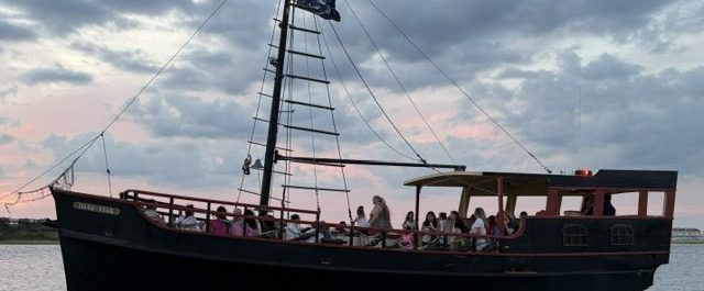 Sailboat on water at sunset, viewed upside down